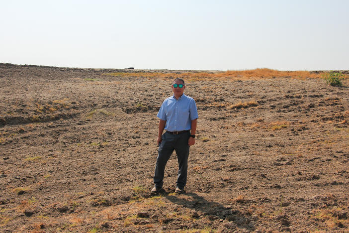 Aaron Fukuda, general manager of Tulare Irrigation District, stands in a basin that's designed to capture floodwater so that it can replenish depleted aquifers.