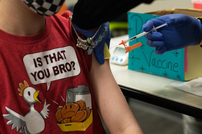 An older child gets vaccinated in Michigan. Pfizer and BioNTech say they will submit a formal request for emergency use authorization of the vaccine in children as young as 5 in the coming weeks.