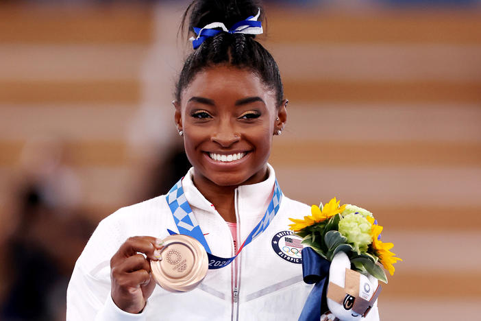 Simone Biles poses with the bronze medal during the Women's Balance Beam Final medal ceremony on day eleven of the Tokyo 2020 Olympic Games on August 03, 2021.