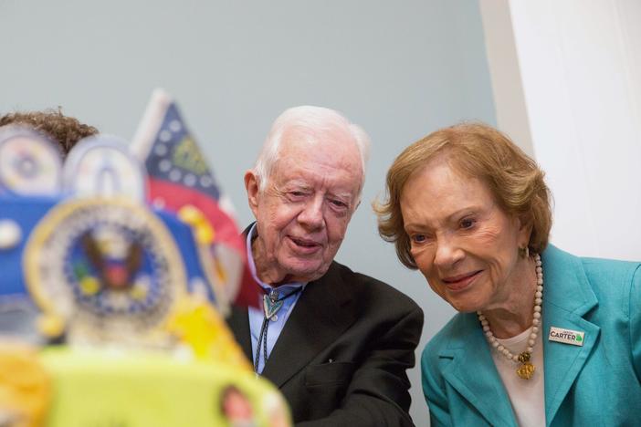 Former first lady Rosalynn Carter looks at a birthday cake with her husband, former President Jimmy Carter, during his 90th birthday celebration held at Georgia Southwestern University, Oct. 4, 2014, in Americus, Ga.