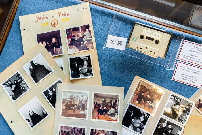 A cassette with the recording of teenage journalists' 1970 interview with John Lennon and Yoko Ono, along with polaroid photos from the conversation, seen at Bruun Rasmussen Auction House in Copenhagen on September 24, 2021. An unidentified bidder won the lot for the equivalent of $58,240.