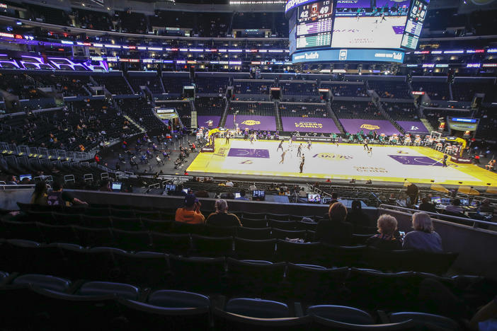 Fans practice social distancing during a game between the Boston Celtics and the Los Angeles Lakers on April 15 in Los Angeles. With a new season set to begin soon, some players are hesitant to get a COVID-19 vaccine.