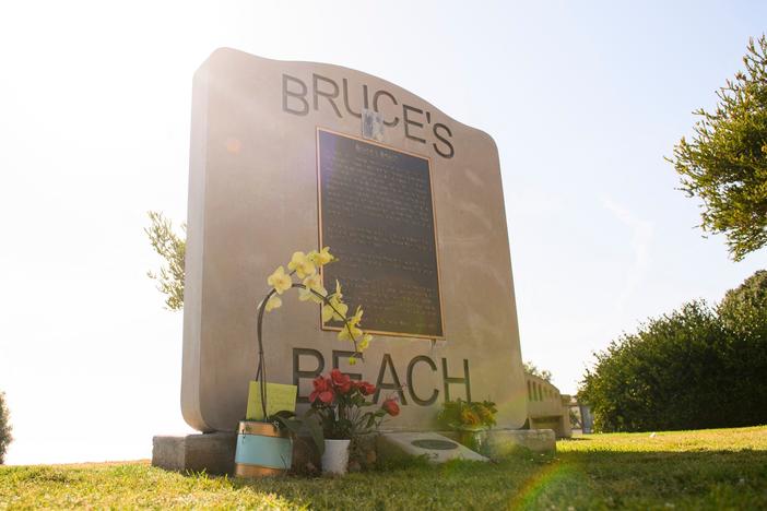 Flowers in support of the Bruce family and George Floyd stand at Bruce's Beach in April in Manhattan Beach, Calif.