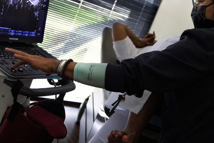 Glenda Lima, a surgical tech at Houston Women's Reproductive Services, performs an ultrasound on a patient on Sept. 30. The patient drove to the clinic from Louisiana, and the ultrasound was to determine whether the woman was less than six weeks pregnant and eligible to have an abortion in Texas, which has enacted the strictest anti-abortion law in the United States.