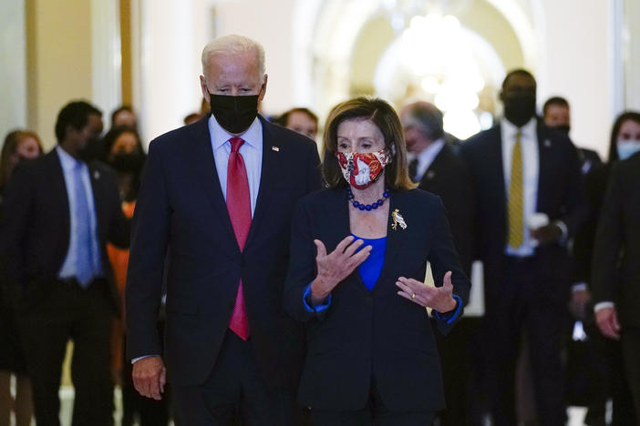 President Biden walks with House Speaker Nancy Pelosi on Capitol Hill on Friday after attending a meeting with the House Democratic Caucus to try to resolve an impasse around the bipartisan infrastructure bill.