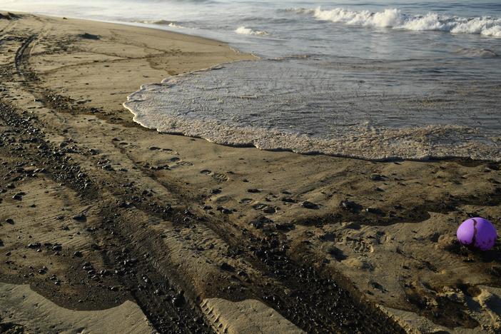 Oil is seen on the beach in Huntington Beach, California on October 3, 2021, after a pipeline breach connected to an oil rig off shore started leaking oil, according to an Orange County Supervisor.