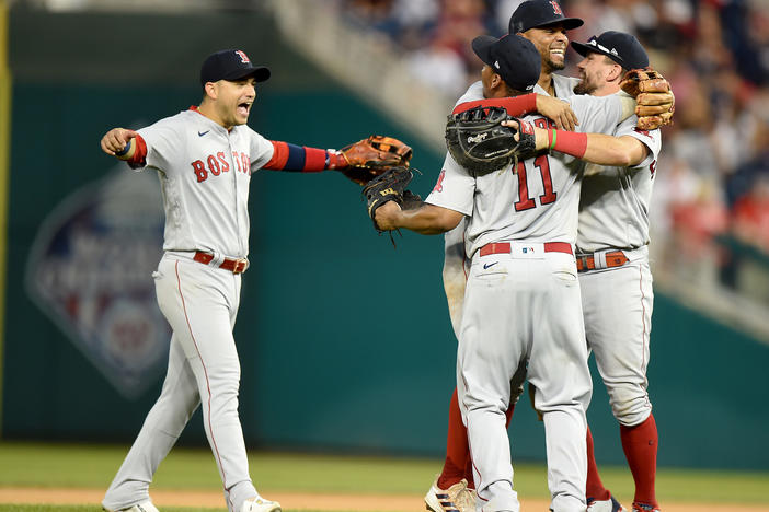 Players for the Boston Red Sox celebrate after a 7-5 victory against the Washington Nationals on Sunday. The Red Sox will play the New York Yankees in the American League wild card game on Tuesday.