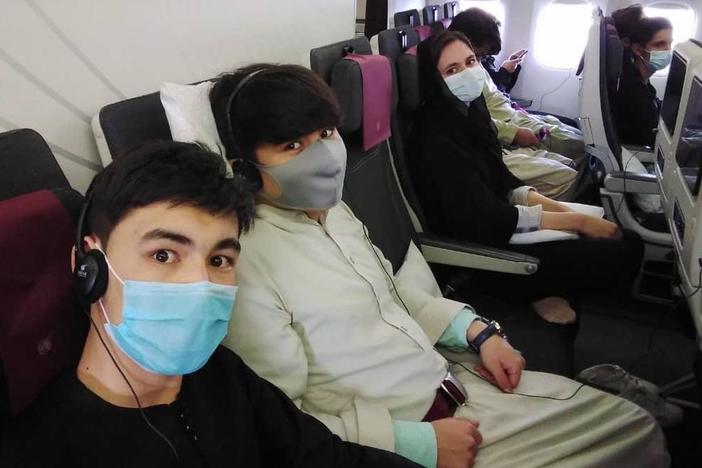 Members of the Afghanistan National Institute of Music on the plane to Doha.
