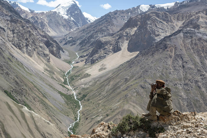 A Wakhi man looks out at the mountains in the Wakhan corridor of Afghanistan. Uyghurs leaving China have trekked through the region. Now many Uyghurs in Afghanistan fear the Taliban could deport them to China.