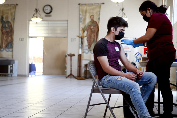 A person receives the Pfizer COVID-19 vaccine at a clinic at St. Patrick's Catholic Church in Los Angeles in April.