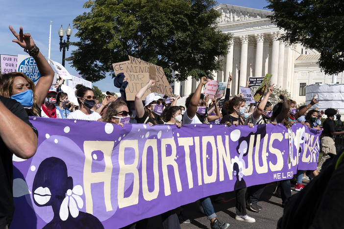 Thousands of demonstrators march outside the U.S. Supreme Court during the Women's March in Washington, Saturday, Oct. 2, 2021.