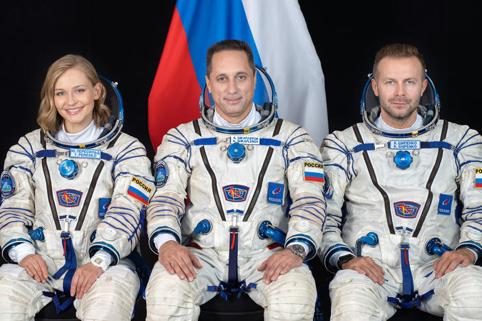 Cosmonaut Anton Shkaplerov (center), along with film director Klim Shipenko (right) and actor Yulia Peresild (left) pose for a photo ahead of the launch of the Soyuz MS-19 spacecraft to the International Space Station from Kazakhstan's Baikonur Cosmodrome.
