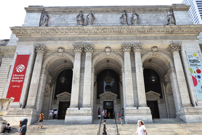 People walk along the stairs of the New York Public Library on July 06, 2021 in Midtown Manhattan in New York City.