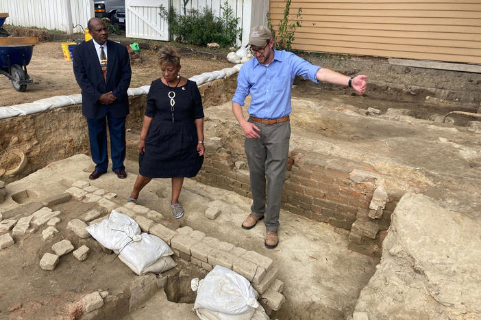 Reginald F. Davis, from left, pastor of First Baptist Church in Williamsburg, Connie Matthews Harshaw, a member of First Baptist, and Jack Gary, Colonial Williamsburg's director of archaeology, stand at the brick-and-mortar foundation of one the oldest Black churches in the U.S. on Wednesday, Oct. 6, 2021, in Williamsburg, Va.