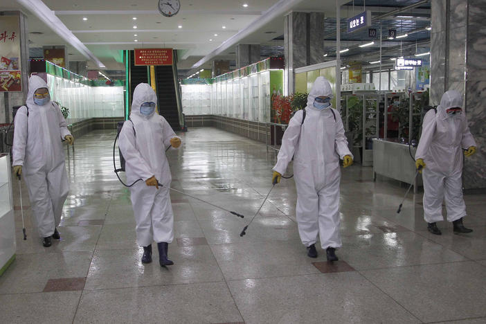 In this Dec. 28, 2020, file photo, staff of the Pyongyang Department Store No. 1 disinfect the store to help curb the spread of the coronavirus before it opens in Pyongyang, North Korea.
