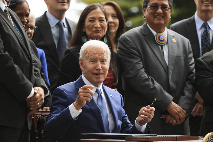 President Biden finishes signing one of three executive orders to expand the areas of three national monuments during an event at the White House on Friday.