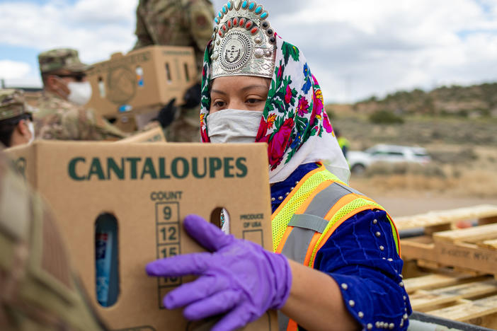 Shaandiin Parrish, who was then Miss Navajo Nation, grabs a box filled with food and other supplies to distribute to Navajo families on May 27, 2020, in Counselor on the Navajo Nation Reservation, New Mexico.