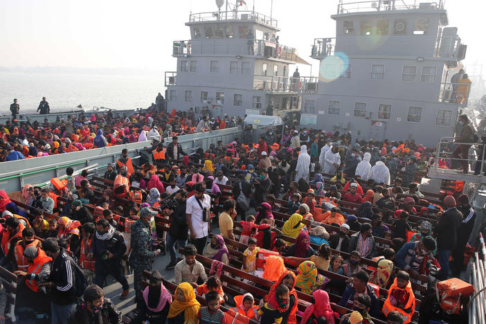 In this Dec. 29, 2020, file photo, Rohingya refugees wait on naval ships to be transported to an isolated island in the Bay of Bengal, in Chittagong, Bangladesh.