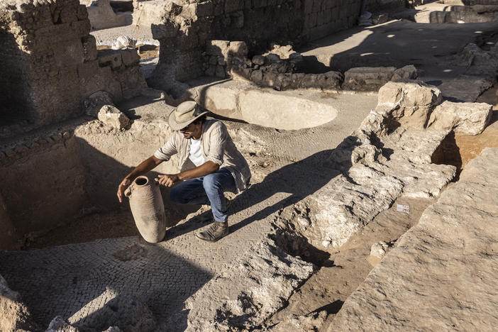 Avshalom Davidesko, from the Israel's Antiquities Authority, examines a jar in a massive ancient winemaking complex dating back some 1,500 years in Yavne, south of Tel Aviv, Israel.
