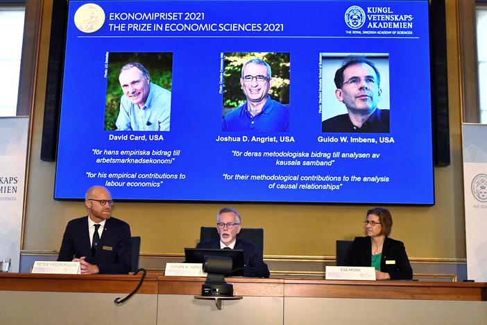 Goran K. Hansson (C), Permanent Secretary of the Royal Swedish Academy of Sciences, and Nobel Economics Prize committee members Peter Fredriksson (L) and Eva Mork (R) give a press conference to announce the winners of the 2021 Sveriges Riksbank Prize in Economic Sciences in Memory of Alfred Nobel.