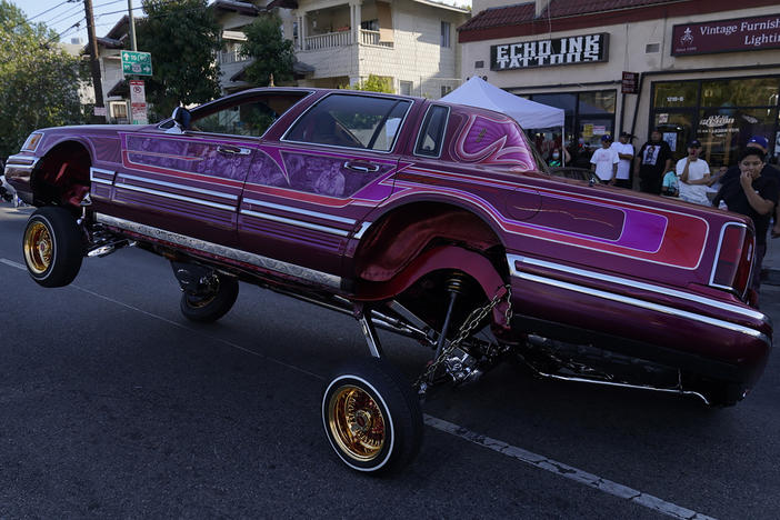 A Lowrider rides on three-wheels on Sunset Blvd., in the Echo Park neighborhood of Los Angeles in July.