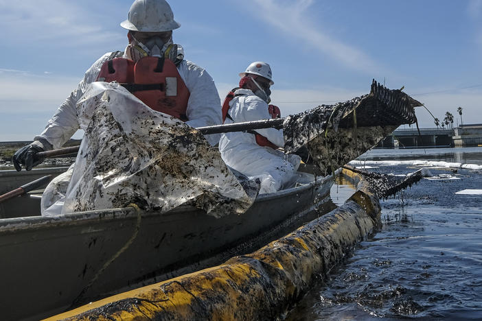 Cleanup contractors deploy skimmers and floating barriers known as booms to try to stop further crude oil incursion into Talbert Marsh in Huntington Beach, Calif., on Oct. 3 after an oil spill off the Southern California coast.