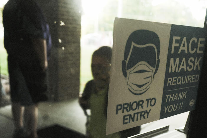 In federal lawsuits, parents in Wisconsin are blaming school districts for coronavirus infections, saying they should not have ended mask requirements during a pandemic. Here, a student in Michigan is seen arriving at school in late August.
