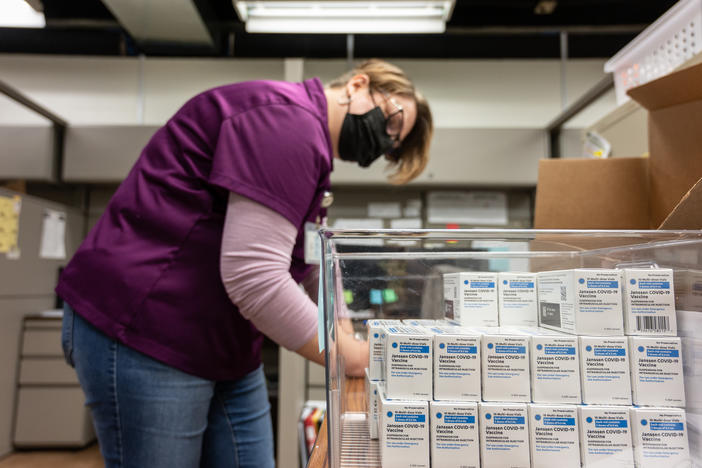 Janet Gerber, a health department worker in Louisville, Ky., processes boxes containing vials of the Johnson & Johnson COVID vaccine in March.