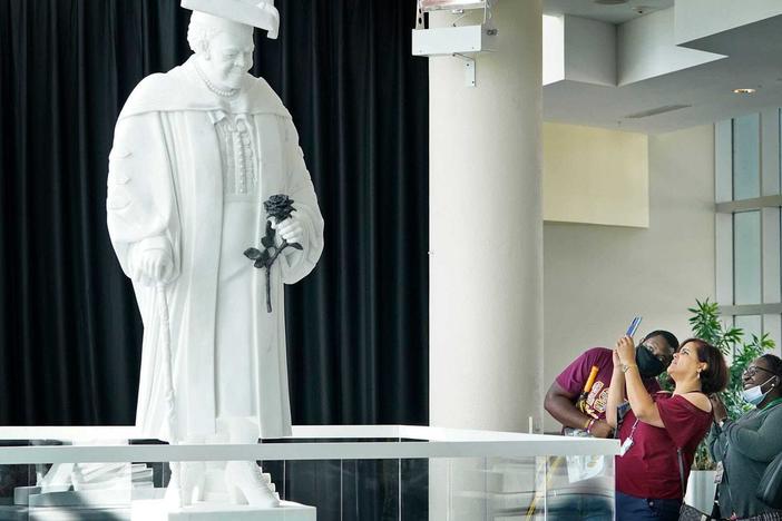 Members of the public view the newly unveiled statue of Mary McLeod Bethune at the News-Journal Center in Daytona Beach on Oct. 12. It's slated to move to the U.S. Capitol's National Statuary Hall early next year.