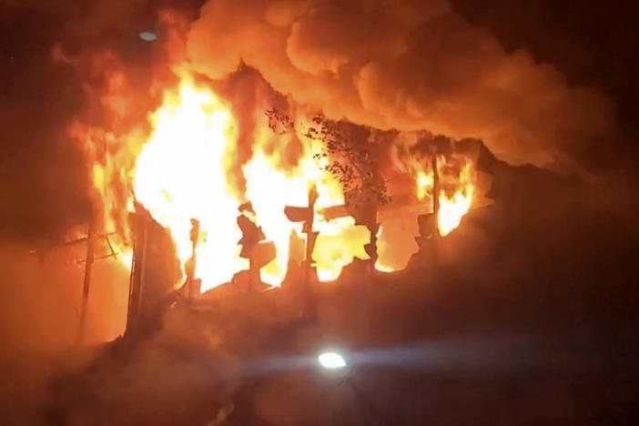 In this image taken from a video, fire and smoke pour out from a building in Kaohsiung, in southern Taiwan on Thursday. The fire engulfed a 13-story building overnight.