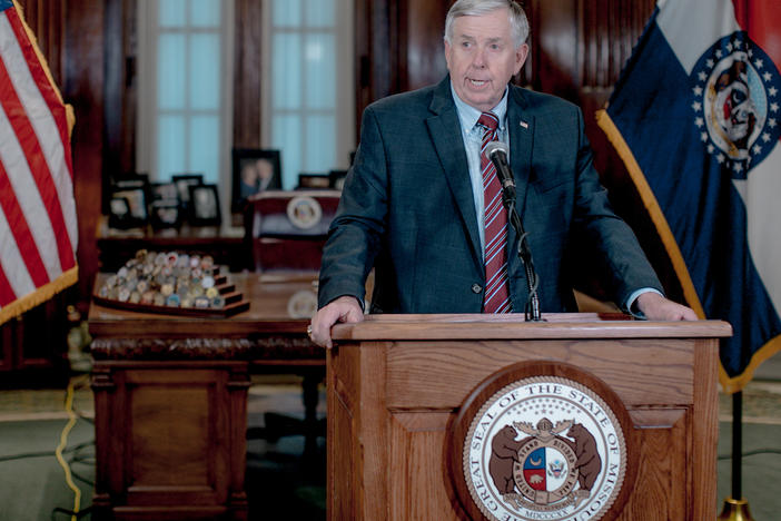 Missouri Gov. Mike Parson, pictured here at a news conference in May 2019, said on Thursday that his administration is pursuing the prosecution of a local newspaper reporter who alerted the government to website security flaws.