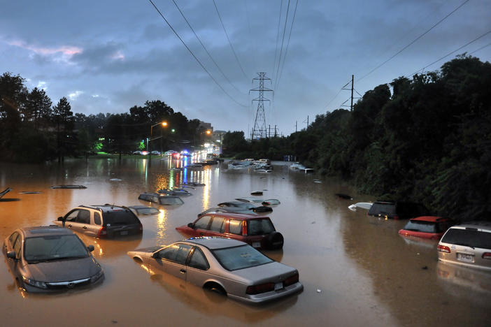 Scenes after heavy rainfall flooded a commuter parking lot in Reston, VA with some cars completely submerged.