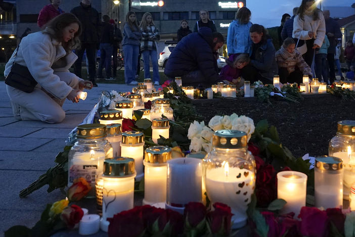 Flowers and candles are placed at the scene of an attack on the square, in Kongsberg, Norway, Thursday. Norwegian authorities say the bow-and-arrow rampage by a man who killed five people in a small town appeared to be a terrorist act. Police identified the attacker as Espen Andersen Braathen, a 37-year-old Danish citizen, who was arrested Wednesday night.