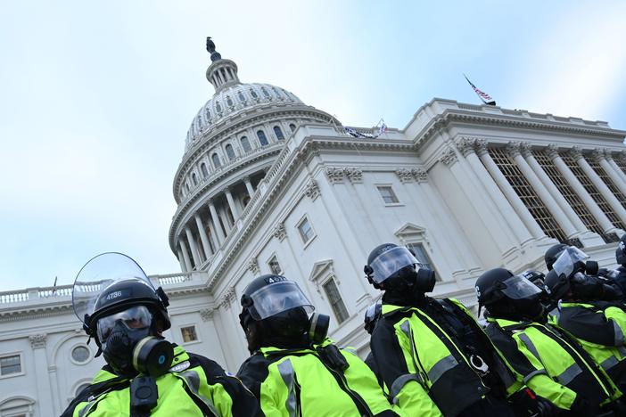 Police stand in a line outside the U.S. Capitol on Jan. 6, 2021.