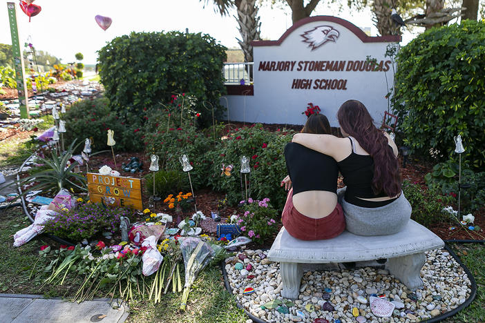 Mourners visit a memorial outside of Marjory Stoneman Douglas High School in Parkland, Fla., in 2020, on the two-year anniversary of the Parkland shootings.