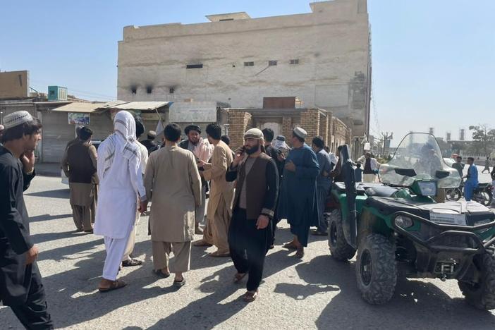 People gather at the scene after a bomb blast hits a Shiite mosque in Afghanistan's southern Kandahar province on Friday.