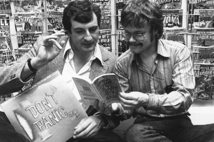 British author Douglas Adams, left, and Nick Landau read Adams' book <em>The Hitchhiker's Guide To The Galaxy</em> in October 1979.