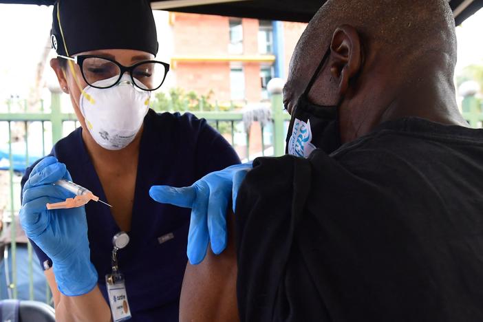 Nurse Christina Garibay administers Johnson & Johnson's COVID-19 vaccine to a man at a community outreach event in Los Angeles in August.