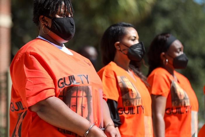 Outside of the Glynn County Courthouse, Ahmaud Arbery's aunt, Thea Brooks, joins a group during a demonstration calling for the conviction of the three men who face charges in the death of Ahmaud Arbery and other county officials they say were complicit in his death.