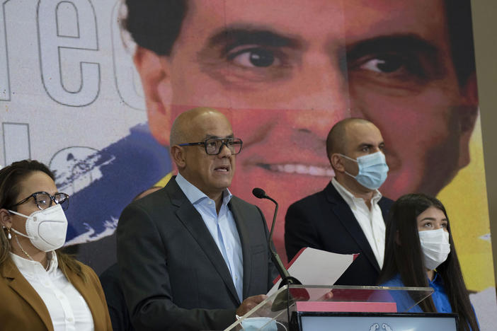 Venezuelan President of the National Assembly Jorge Rodriguez, center, speaks to the press as an image of Colombian businessman and Venezuelan special envoy Alex Saab is in the back in Caracas, Venezuela, Saturday, Oct 16, 2021.