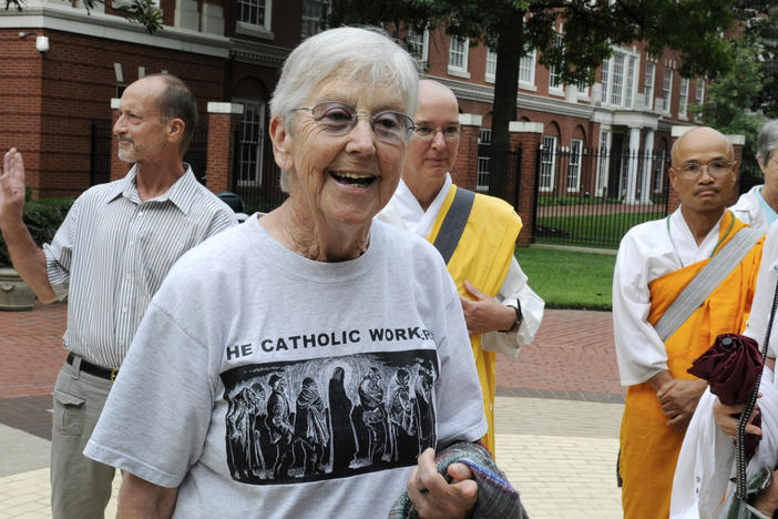Sister Megan Rice, center, and Michael Walli, in the background waving, are greeted by supporters in 2012 as they arrive for a federal court appearance in Knoxville, Tenn., after being charged with sabotaging a government nuclear complex. Rice died on Oct. 10 in Rosemont, Pa. She was 91.