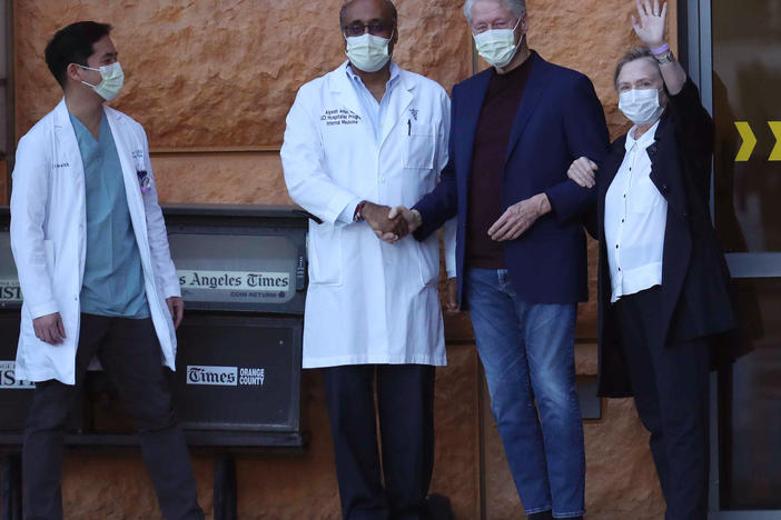 Former President Bill Clinton, standing with his wife, Hillary, and doctors, was discharged from UC Irvine Medical Center Sunday morning.