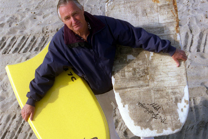 Tom Morey, inventor of the Boogie Board, is photographed on Capistrano Beach holding a newer model (left) and (right) his original 1971 Boogie Board.
