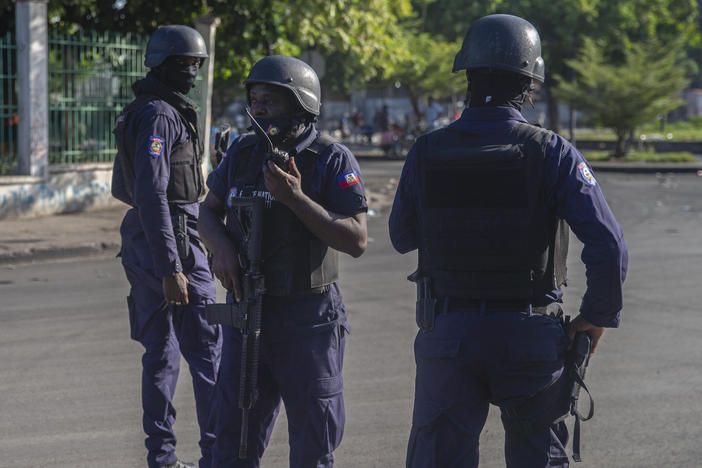 Armed forces secure the area where Haiti's prime minister, Ariel Henry, placed a bouquet of flowers in front of a memorial to independence hero Jean-Jacques Dessalines in Port-au-Prince, Haiti, on Sunday. Haitian police are working with U.S. officials and are in contact with the kidnappers who abducted a group of U.S.-based missionaries on Saturday.