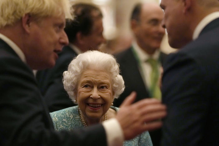 Britain's Queen Elizabeth II and Prime Minister Boris Johnson, left, greet guests at a reception at Windsor Castle, Windsor, England, Oct. 19, 2021.