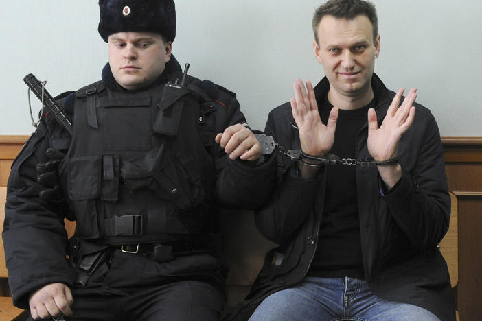 In this March 30, 2017 file photo, Alexei Navalny, right, poses for the press in court in Moscow. The imprisoned Russian opposition leader was awarded the European Union's top human rights prize on Wednesday.