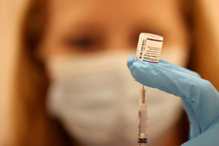 Safeway pharmacist Ashley McGee fills a syringe with the Pfizer COVID-19 booster vaccination at a vaccination booster shot clinic on Oct. 1, in San Rafael, Calif.