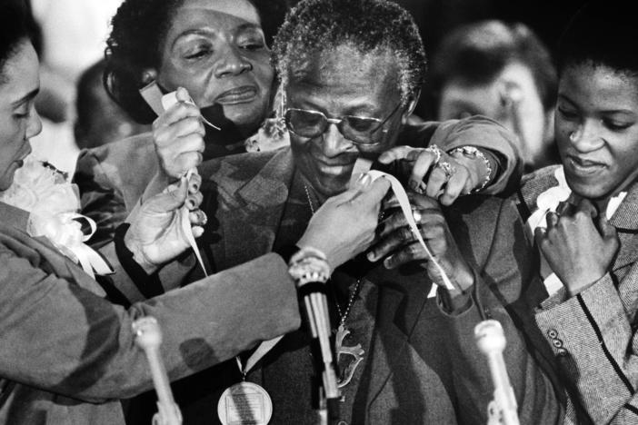 In 1986, South African activist, Nobel Peace Prize recipient and Anglican Archbishop Desmond Tutu receives the Martin Luther King Jr. Nonviolent Peace Prize for his commitment and role during the struggle against apartheid, from Coretta Scott King (left), her daughter Christine King Farris (rear) and Tutu's daughter Nontombi Naomi Tutu.