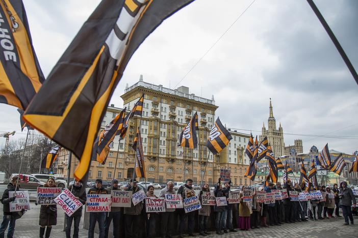 Russian demonstrators hold anti-American posters outside the U.S. Embassy in 2015. From the 1960s through the 1980s, the U.S. said the Soviet Union beamed microwave signals at the U.S. Embassy in an attempt to collect intelligence.