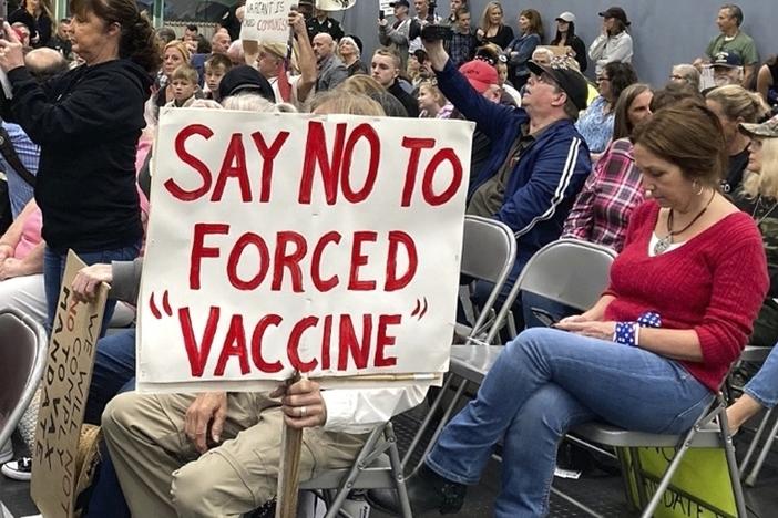At a meeting in Concord, New Hampshire, on Oct. 13, 2021, audience members voice opposition to federal vaccine mandates. Some employers, from state governments to hospitals to private companies, have already begun enforcing their own vaccine mandates, leading to the resignation or firing of a small percentage of workers.